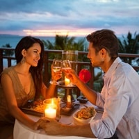 Young couple dating in a romantic dinner under candle light.