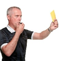 Referee showing yellow card.